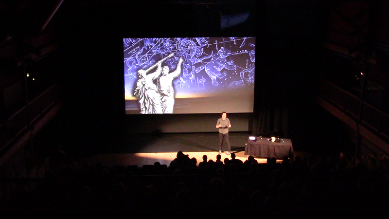 Will Gater speaking on stage during Watch this Space theatre show